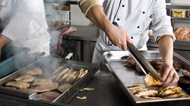 Hospitality workers with trays of food
